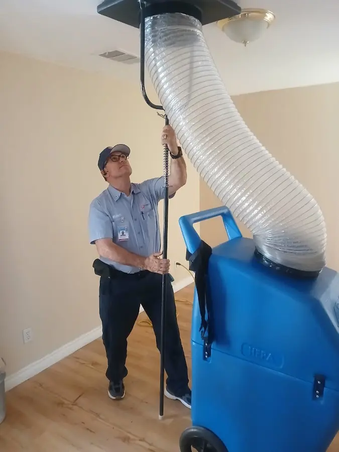 Furnace Tune-Up technician using HEPA equipment in Charlotte